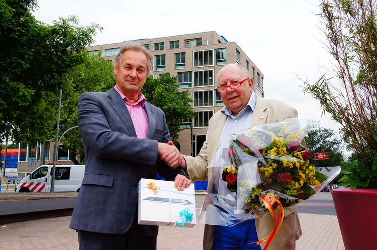 Harry de Boer kreeg uit handen van juryvoorzitter Jan Voskamp de iPad. Op de achtergrond de in aanbouw zijnde Honingraat Foto: Shirley Brandeis, juli 2013 