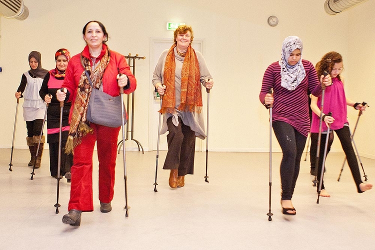 Tijdens het openingsfeest van het Huis van de Wijk Slotermeer demonstreerde een groep vrouwen hoe Nordic walking werkt. Portefeuillehouder Welzijn: Jesse Bos deed ook mee Foto: Thomas Heere 